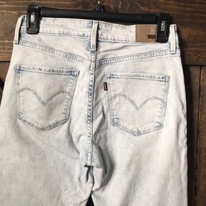 Slightly worn, light wash Levi jeans.